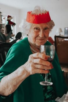 Woman with a christmas hat and glass of wine
