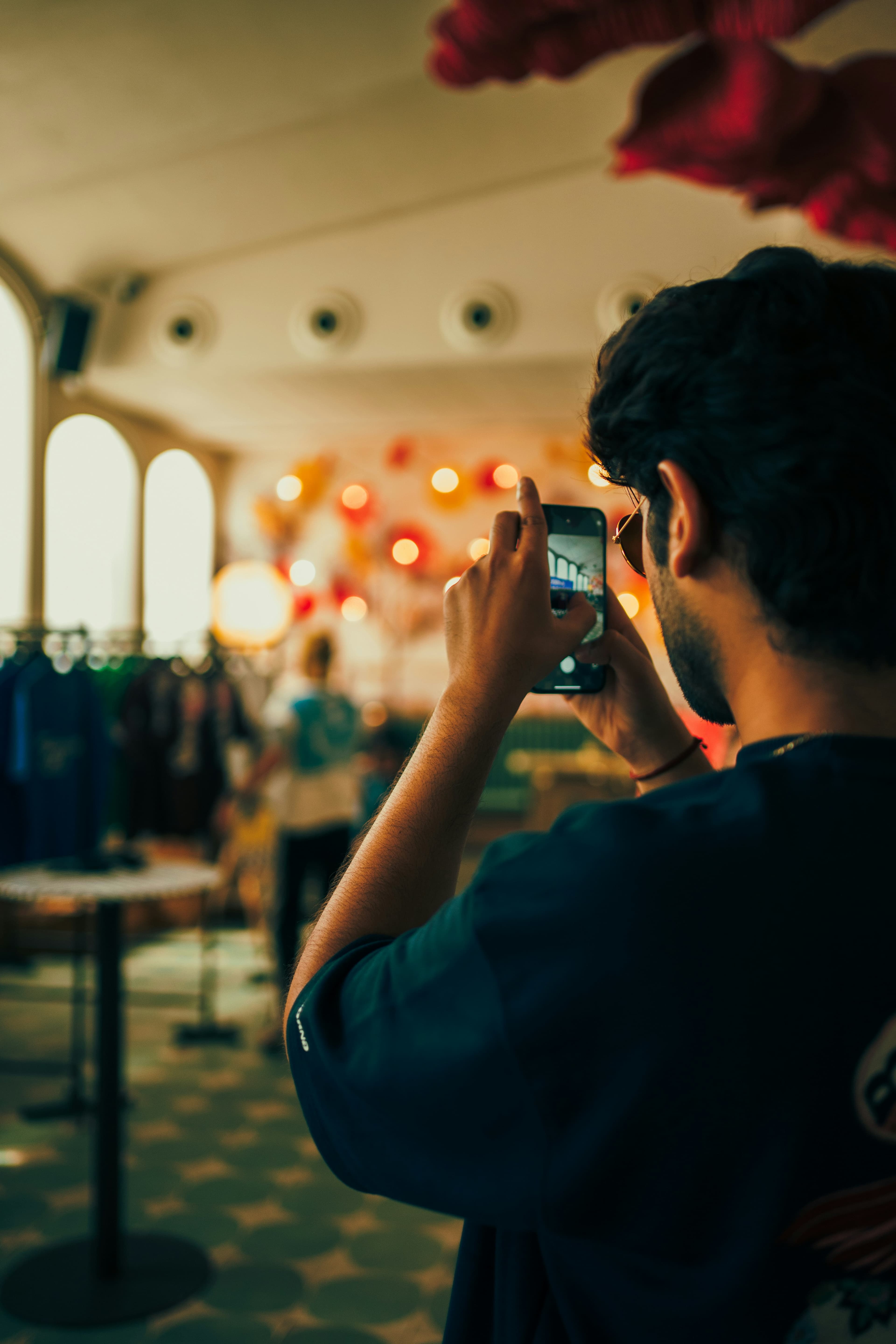 Man photographing items in a shop for online listing